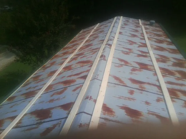 Rusted metal roof panels with new wood purlins before replacement — Storm Damage Roof Repair in Oreland by Roofing Brothers