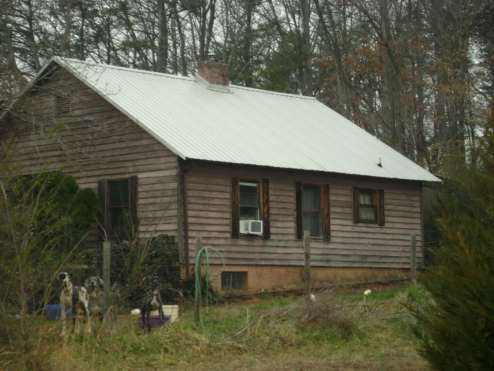 White metal roof on an old wood sided farmhouse, from a Metal Roof Installation job in Oreland